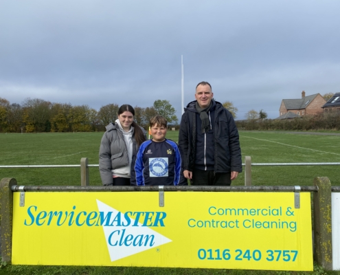 richard stood with ServiceMaster board Syson Rugby Club Leicester